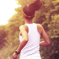 A woman jogging along a country road