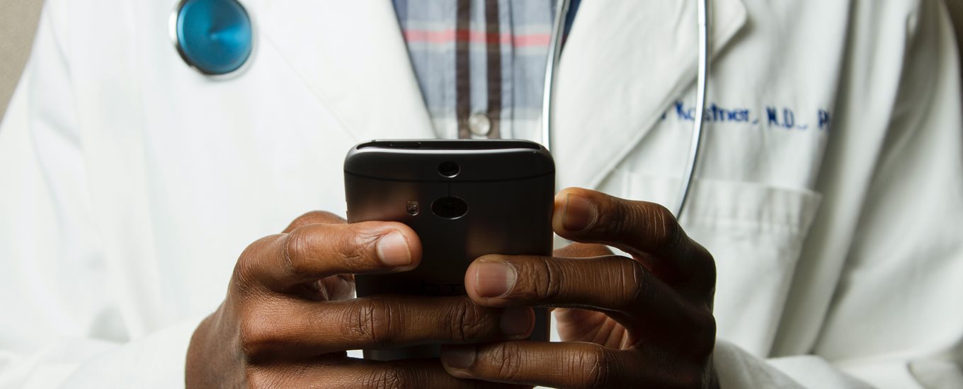 Doctor Holding Cell Phone.