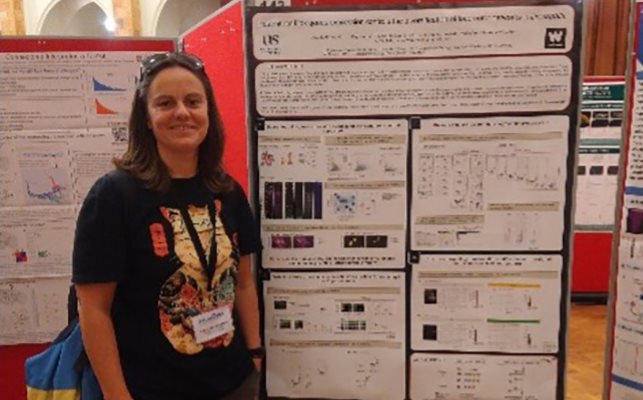 Nadezhda Velichkova, an Early Career Researcher at BSMS, next to a poster at the Neurofly conference