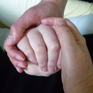 A close up of two people holding hands