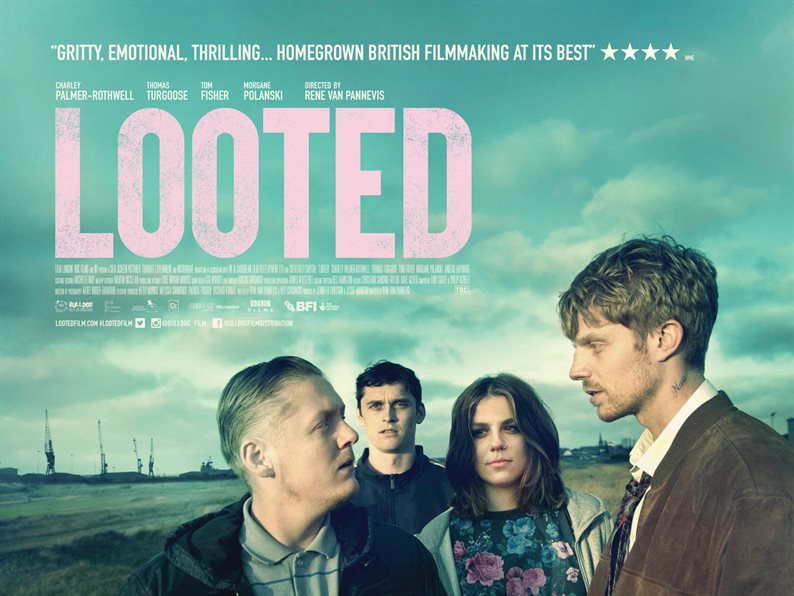 Mid shot of four people stood in a deserted landscape with the film title 'Looted' and cast details written on it