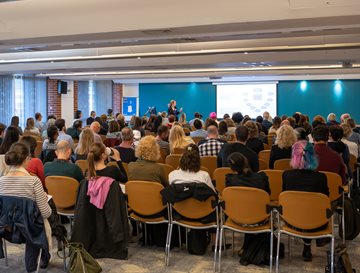 A group of people in a talk at the HRP conference