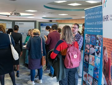 People talking next to banner displays at a conference