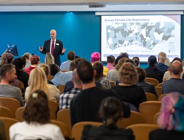 A man talking to a room of people at the HRP conference