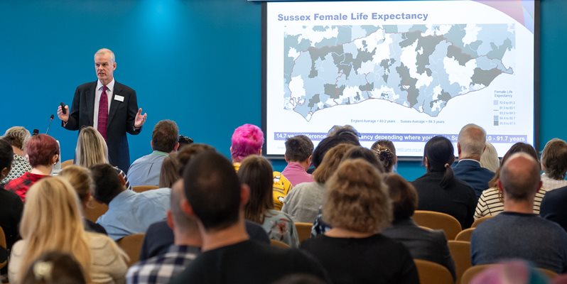 A man talking to a room of people at the HRP conference