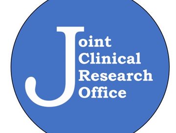 A blue circle with white writing saying Joint clinical research office