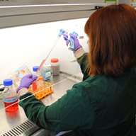 Woman with pipette in lab