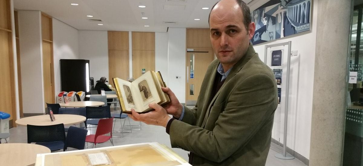Dr Max Cooper with a historical book