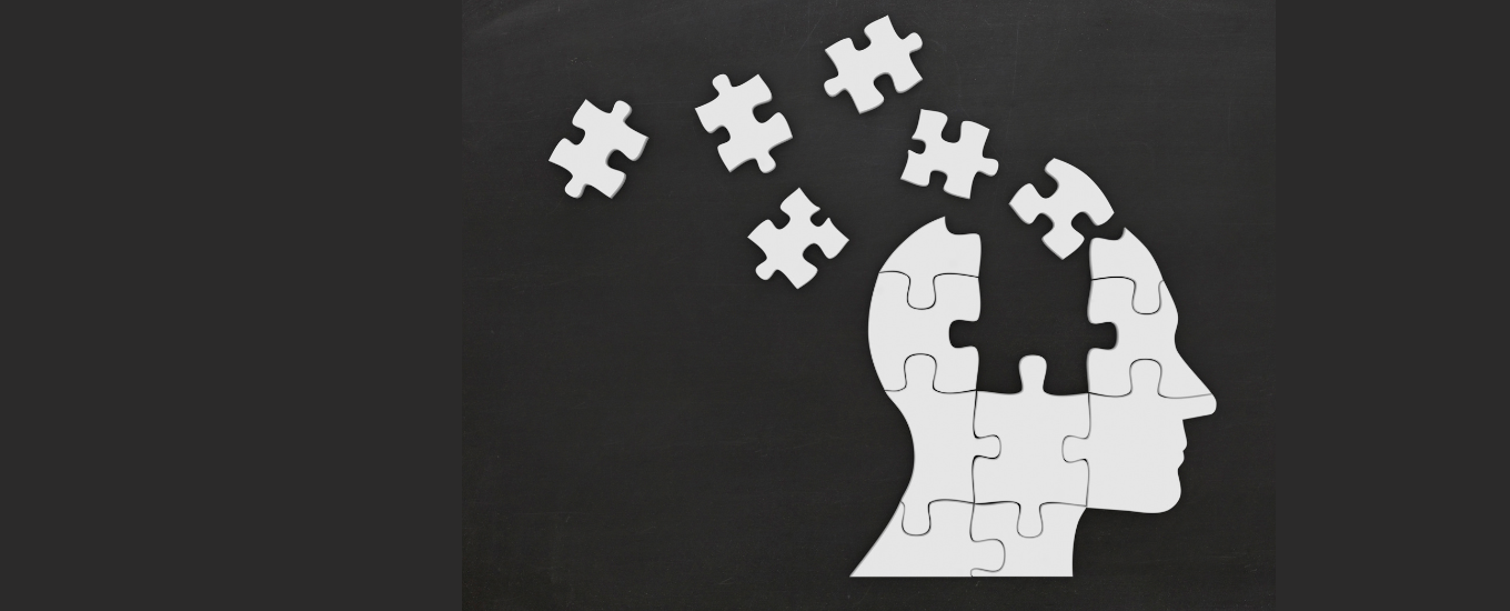 An image of a silhouette head with puzzle pieces missing and scattered around