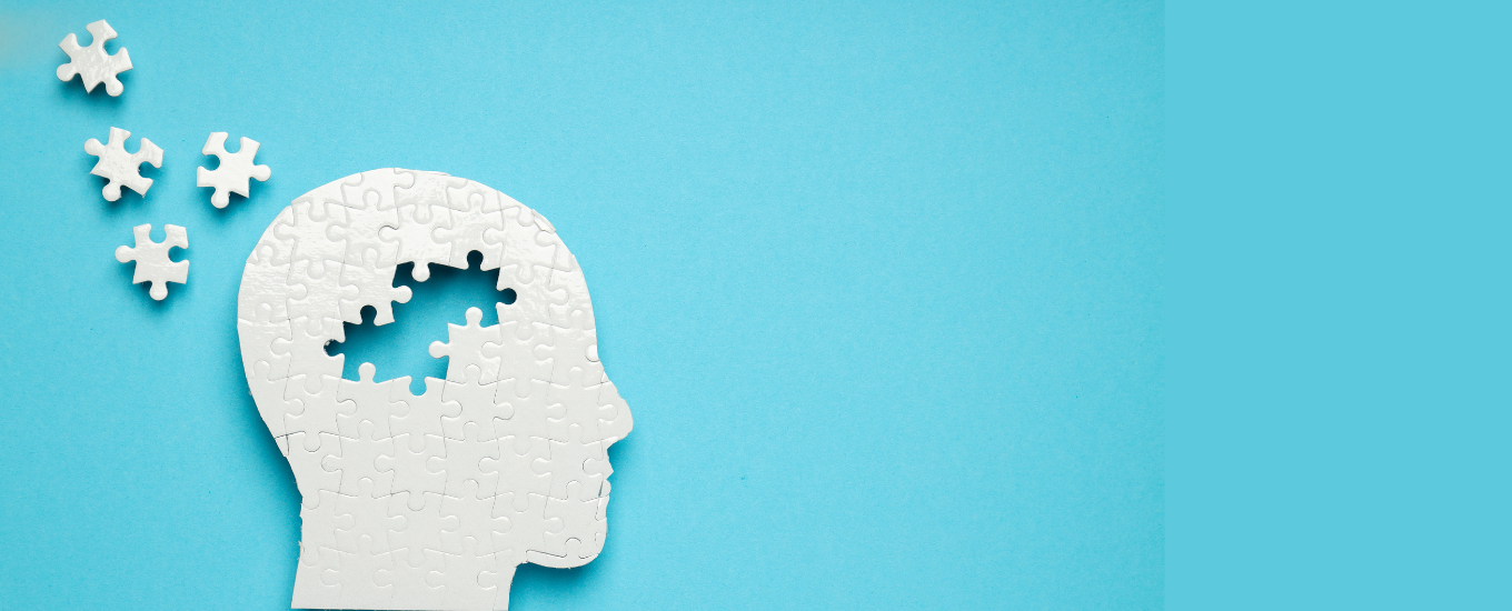 White silhouette head with missing puzzle pieces on a blue background