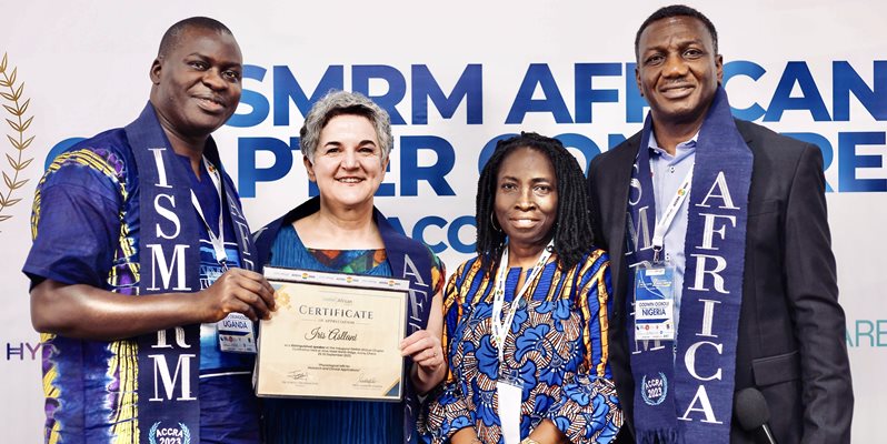 A group of people with a certificate smiling for a photo