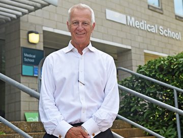 Malcolm Reed standing outside the medical school teaching building