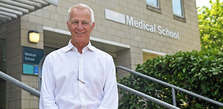 Malcolm Reed standing outside the medical school teaching building