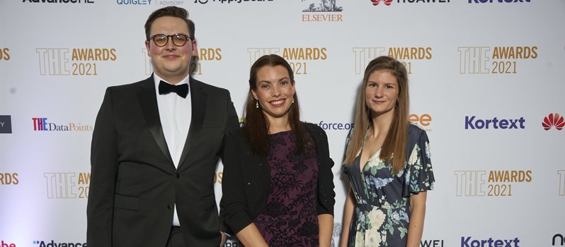 Three of the outreach team from BSMS pictured in front of a sign at the times education awards in smart clothes