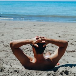 Man sunbathing on a beach