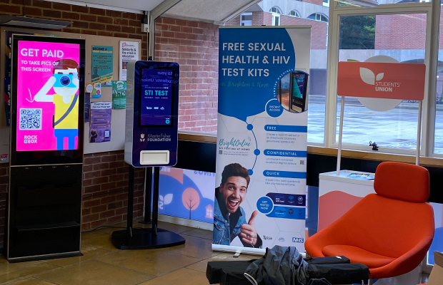 Student Union reception room showing several banners including one advertising free sexual health and HIV test kits