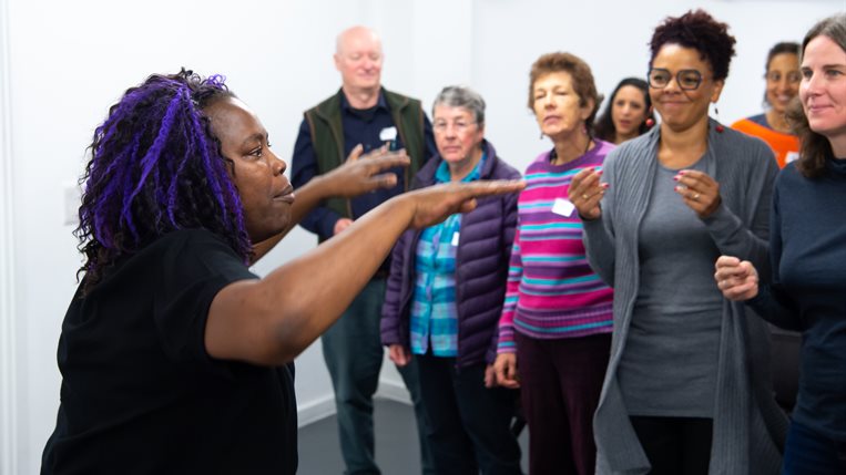 A choir leader leads the choir in song