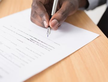 Hand filling out a form