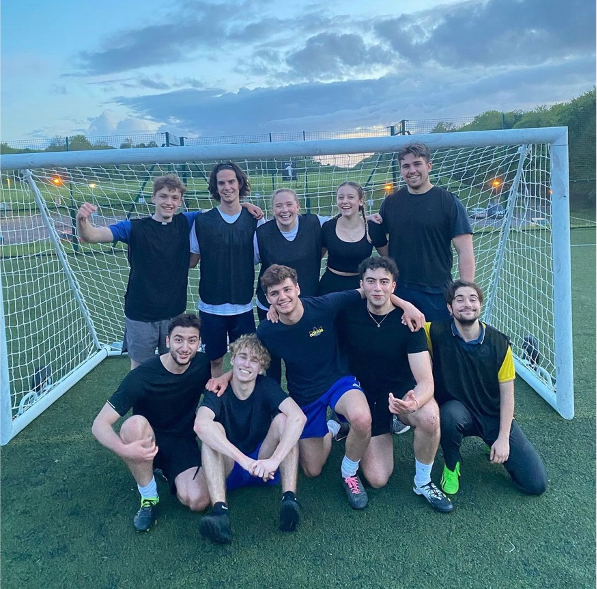 The year 1 football team standing in front of the goal