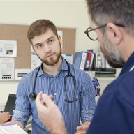 A nurse talking to a student in the hospital