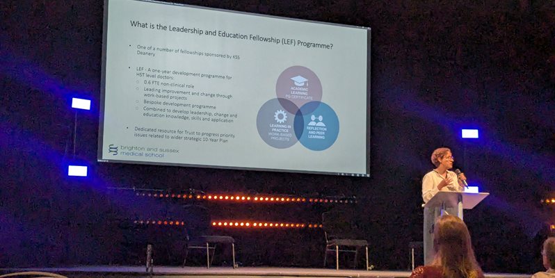 A photo of Jessie Cunnett talking on stage about the BSMS LEF programme
