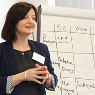 A teacher standing in front of a flipchart