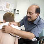 Prof Somnath Mukhopadhyay with a young patient in hospital