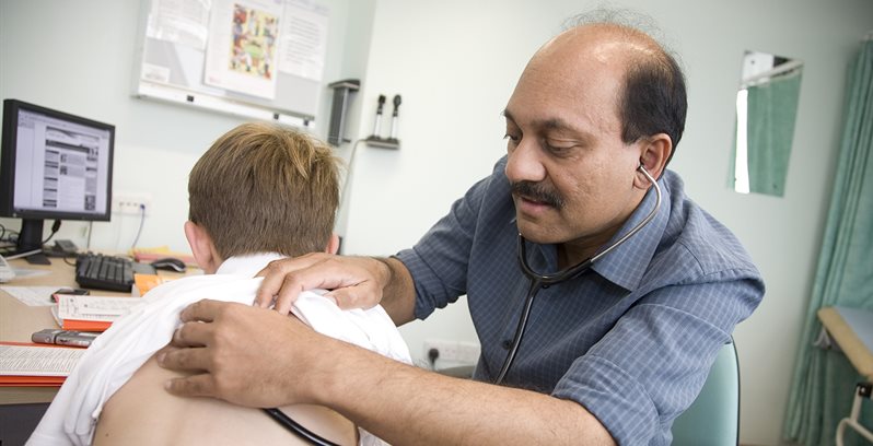 Picture of Somnath Mukhopadhyay and a child patient