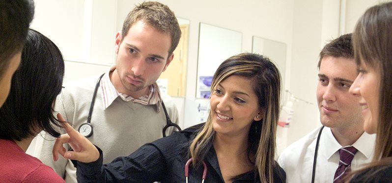 Smiling students in a clinical setting