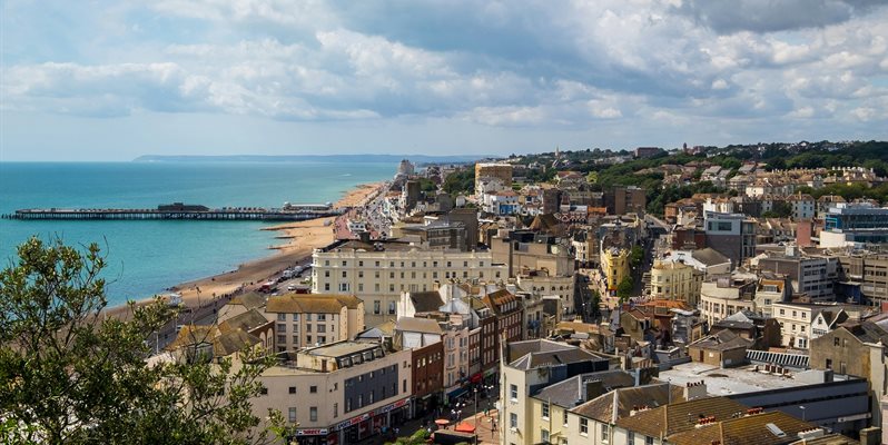 An aerial shot of Hastings showing houses and the sea from a high viewpoint