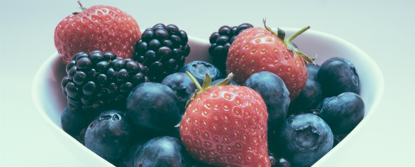 Strawberries, blackberries and blueberries in a heart shaped fruit bowl