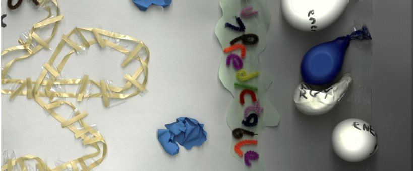 A collage with the words predictable made out of pipe cleaners and deflated balloons that have energy written on them