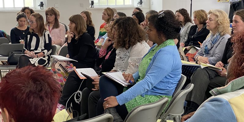 A group of people listening to a talk