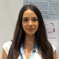 Aimilia Vareli standing in front of her poster presentation