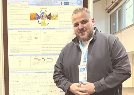 Fisal Tantoush stood in front of his poster presentation