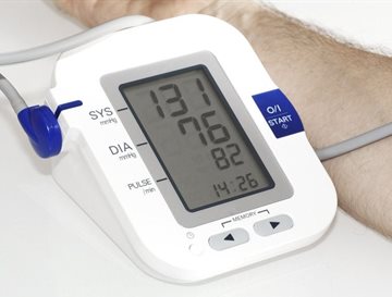 A close up of a monitor showing hypertension being checked on a patient