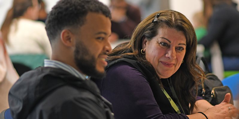 Students and families talking at a time for autism conference