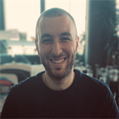 Dr John Shenouda, BSMS alumnus, smiles at the camera in a mid-close up portrait photo