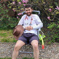 A photo showing Jack Whiting sitting on a chair in a garden