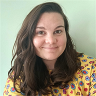 A colour photo of Katie Morrigan, Physician Associate Studies alumna, smiling directly at the camera in medium close up.