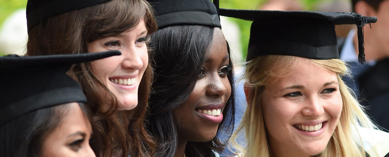 Close up of several graduating students in gowns