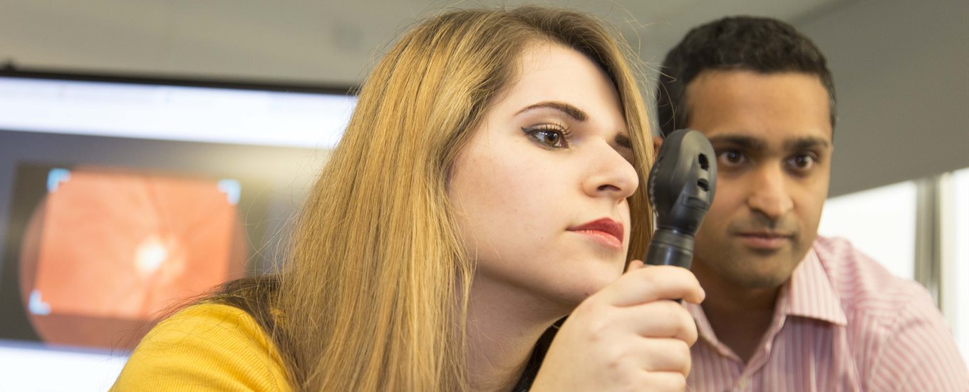 Female student with a tool to examine eyes