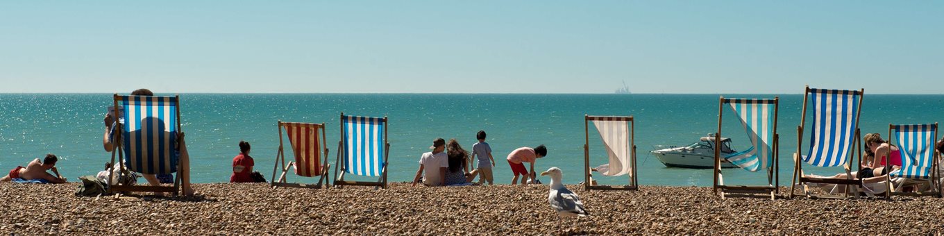 People enjoying sun on Brighton beach front