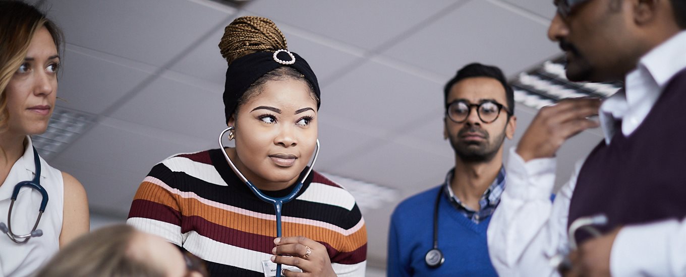 Students in GP session, using a stethoscope