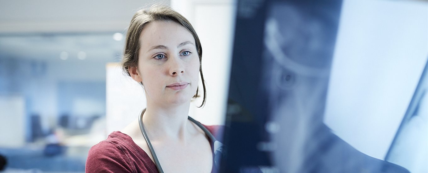 Female student looking at an x-ray