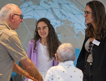 Two students on the Time for Dementia programme talking and smiling with two elderly patients