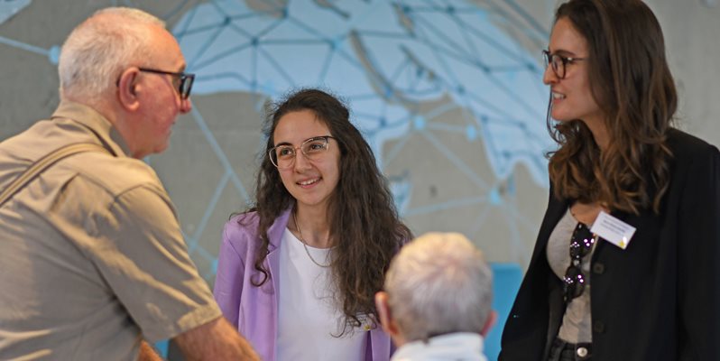 Two students on the Time for Dementia programme talking and smiling with two elderly patients