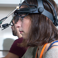 Two people with monitoring equipment on their heads