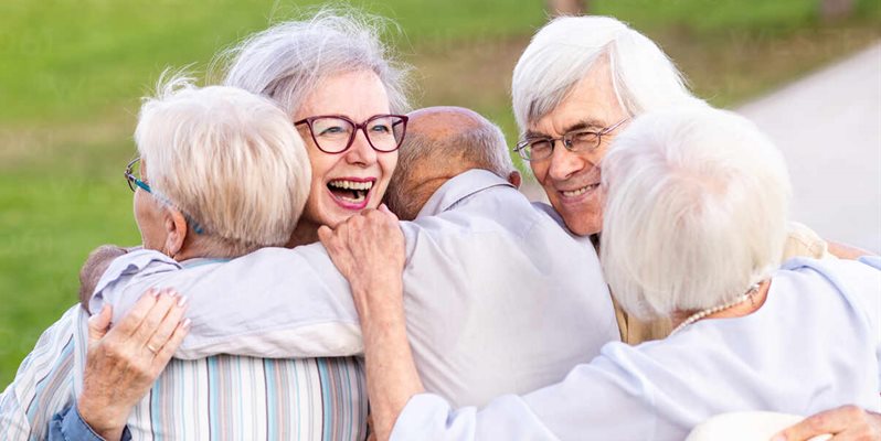 Grandparents hugging their grandchildren
