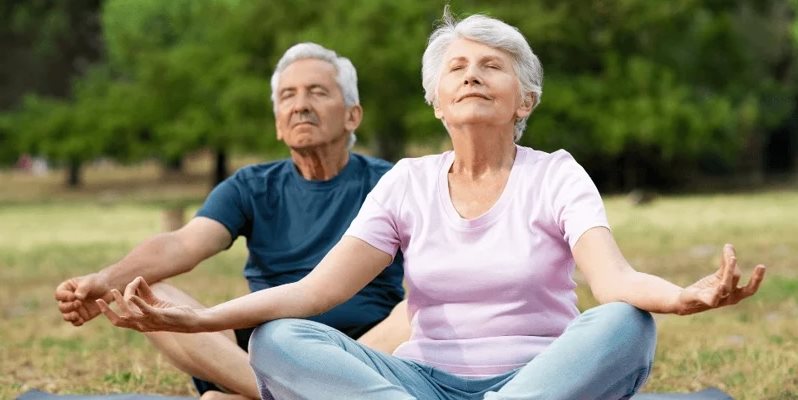 Two elderly people meditating